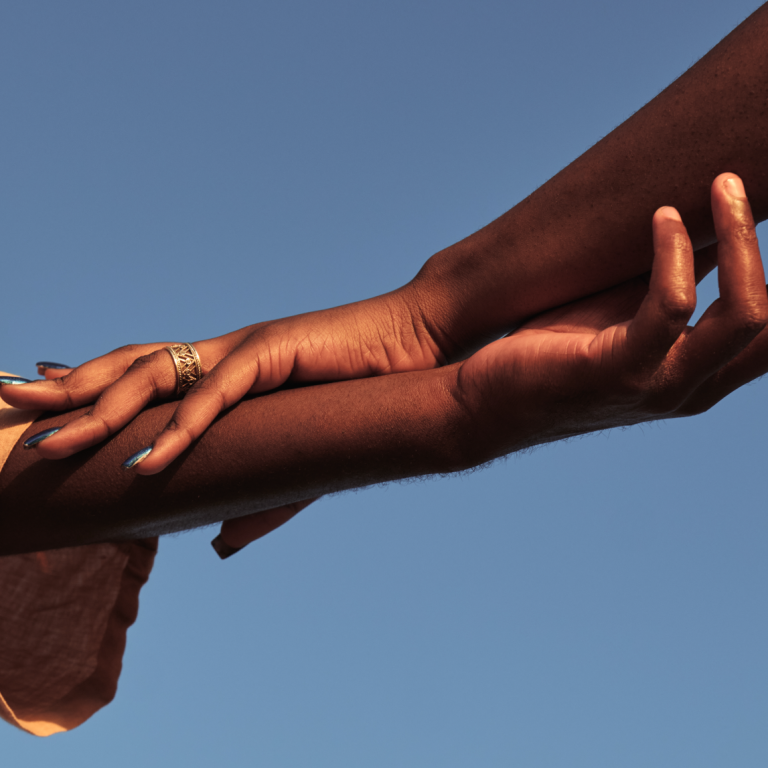 hands-held-together-with-a-ring-under-blue-sky-2026-03-23-23-50-41-utc